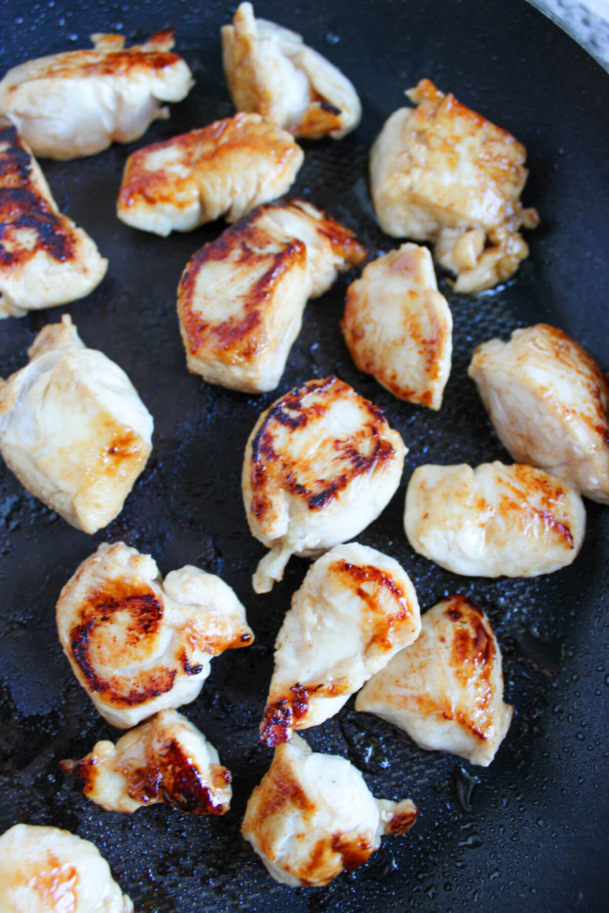 Cooking chicken pieces for easy cashew chicken.