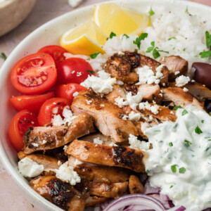 Greek chicken bowl with tzatziki sauce in a bowl for serving.