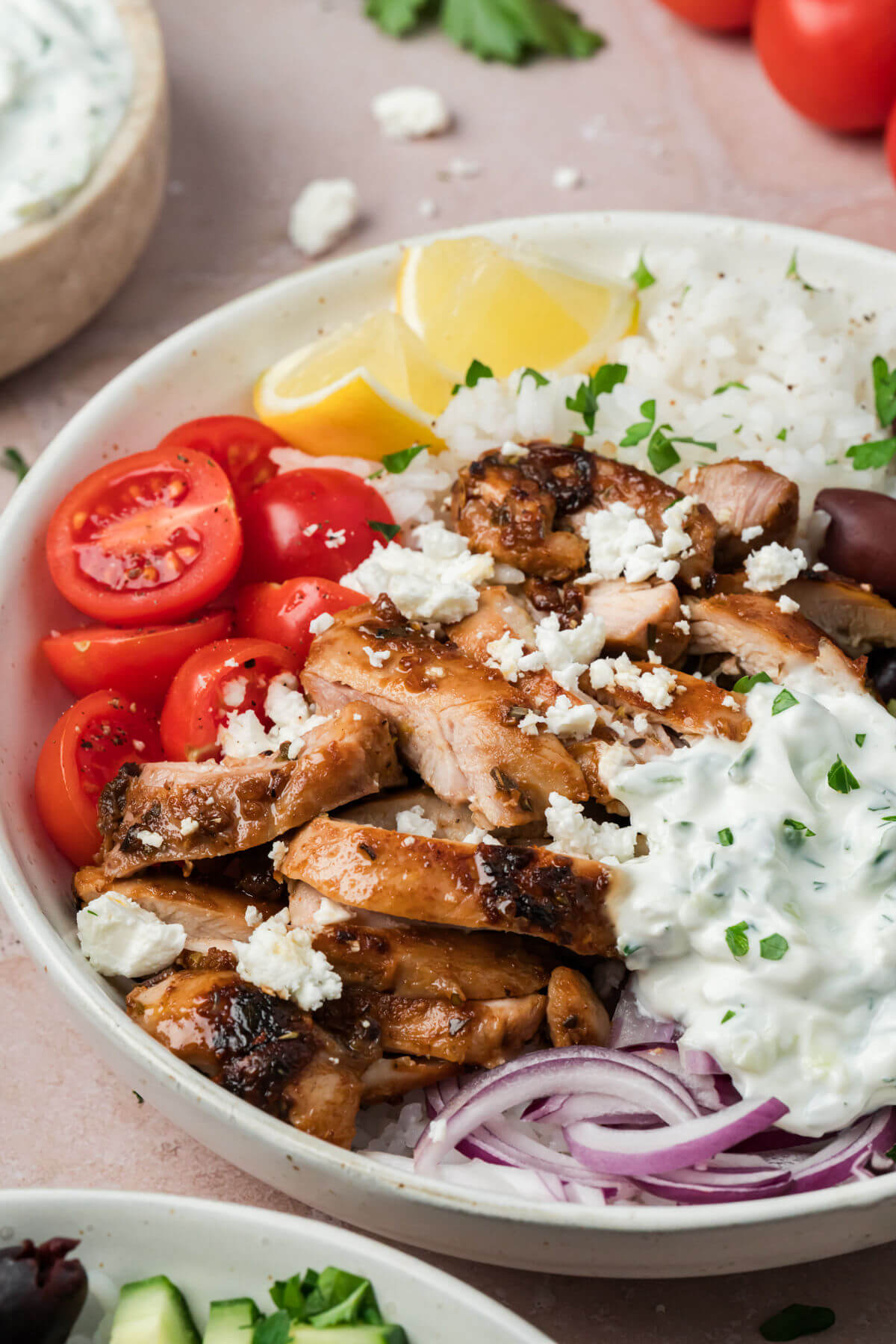 Greek chicken bowl with tzatziki sauce in a bowl for serving.