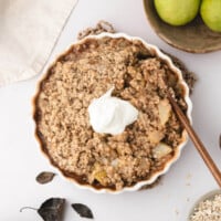 Pear crisp with whipped cream on top.
