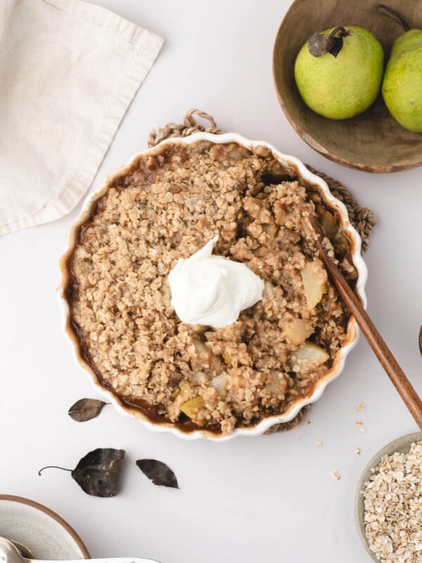 Pear crisp with whipped cream on top.