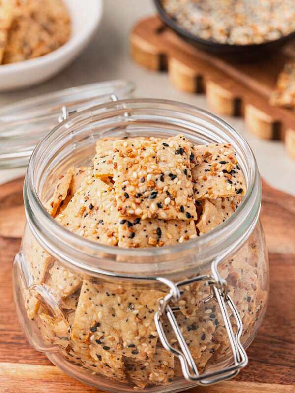 Everything sourdough discard crackers in a glass jar.