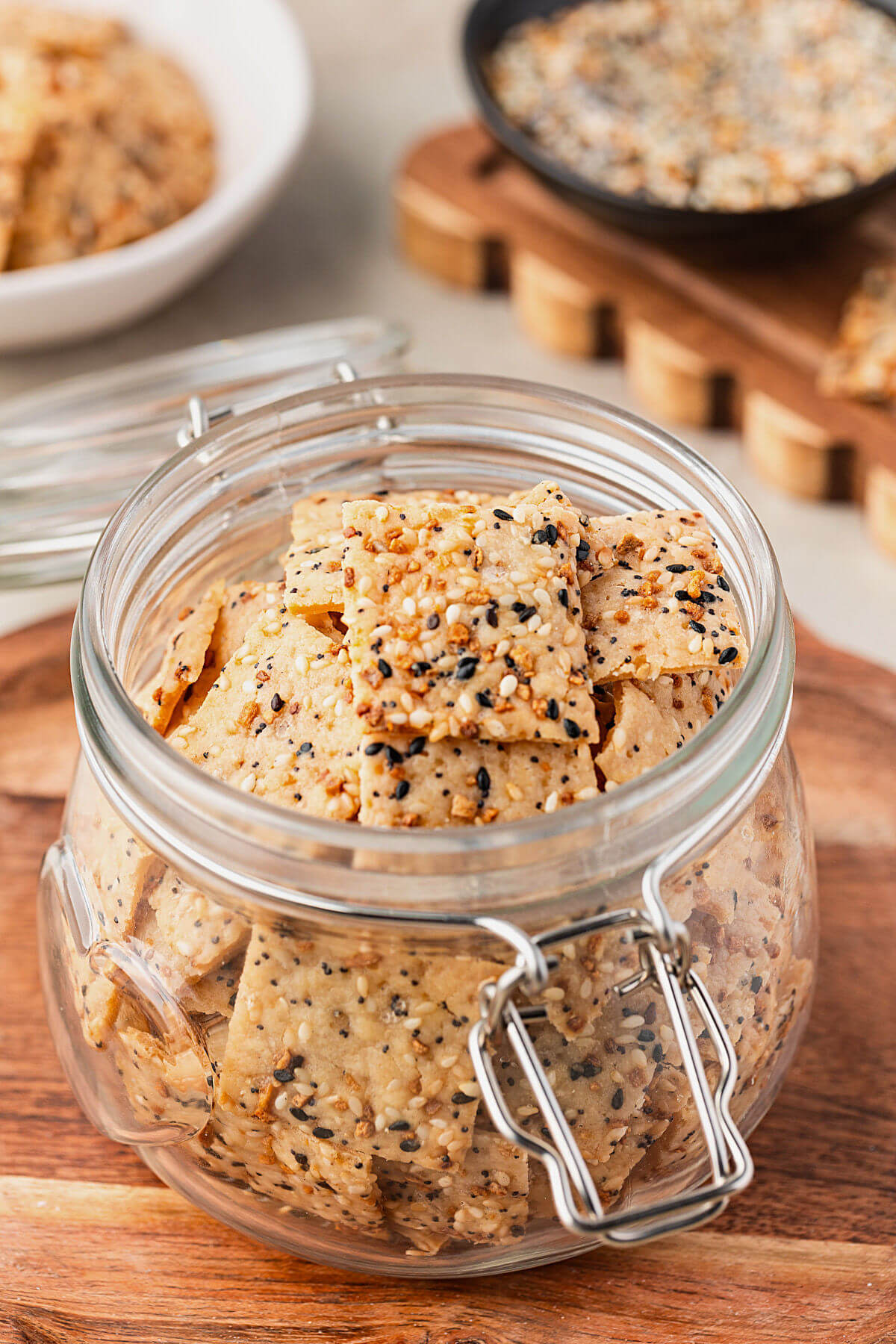 Everything sourdough discard crackers in a glass jar.