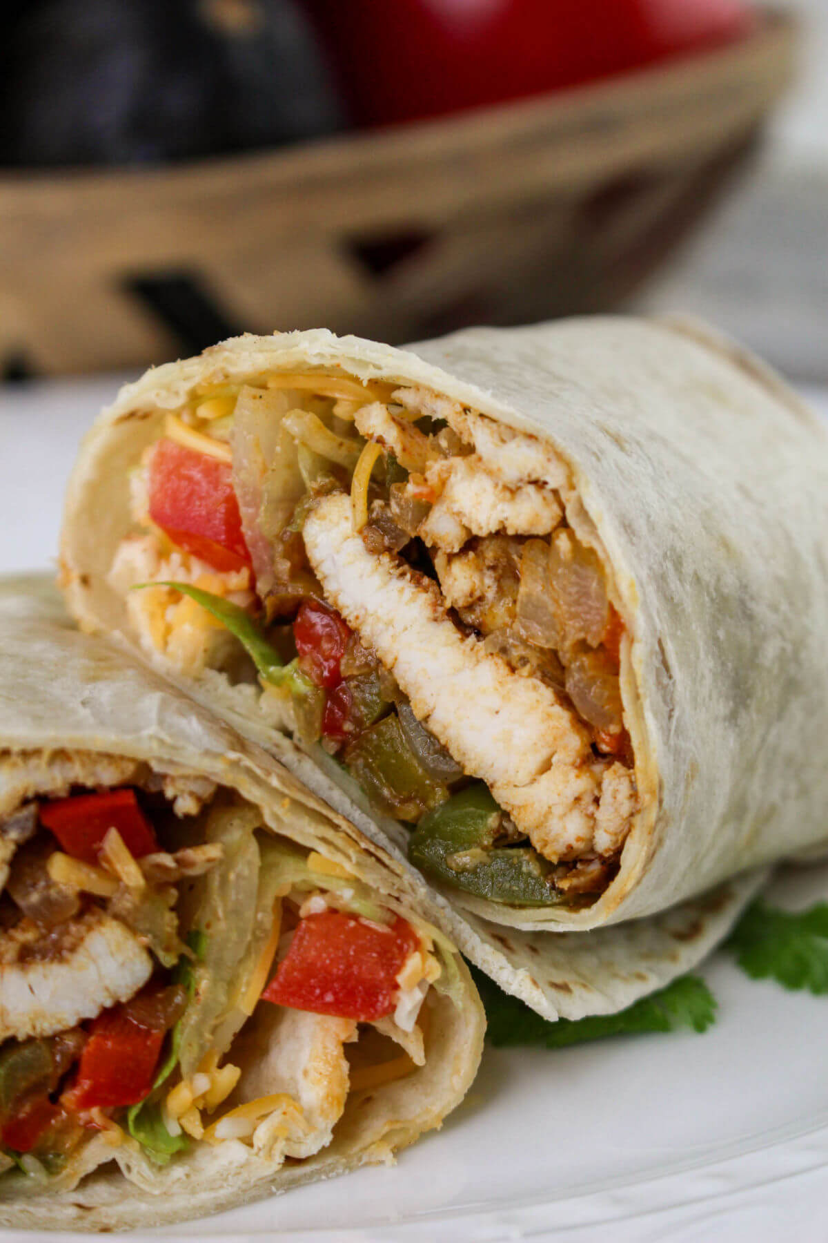 Homemade chicken fajita wraps on a plate.