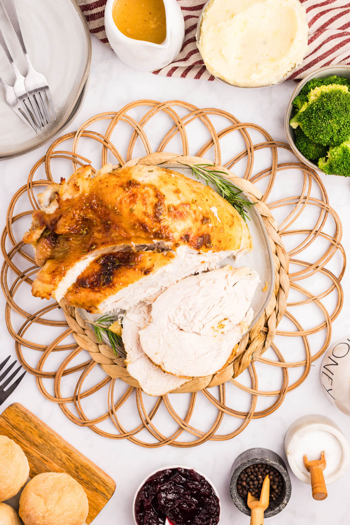 Honey glazed turkey breast on a platter with slices cut off of it.