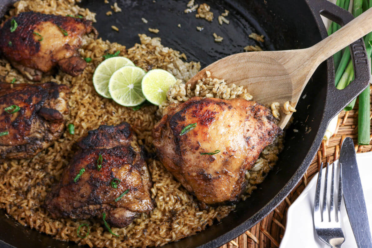 Jerk chicken and rice recipe cooked in a cast iron skillet.