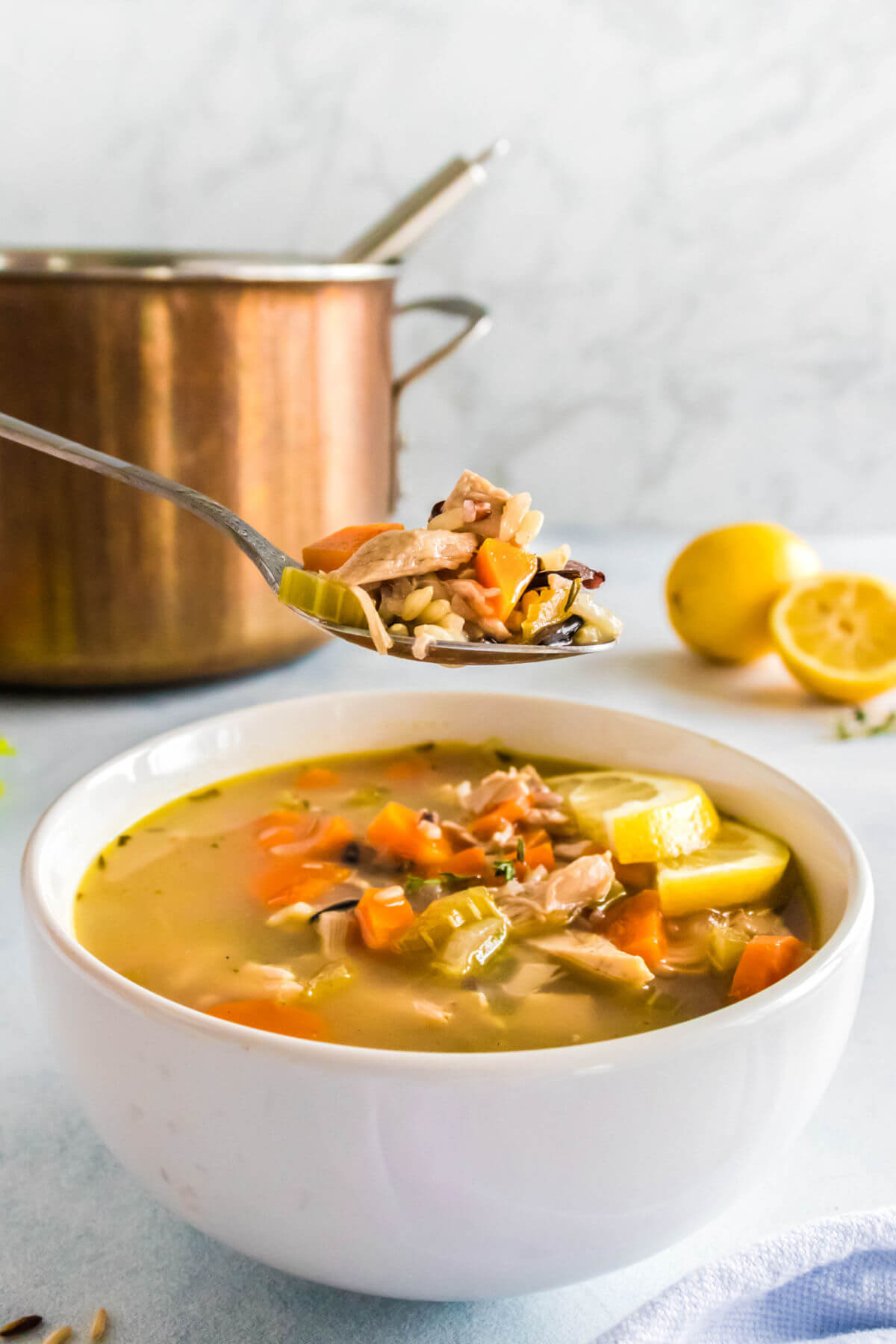 A bowl of lemon chicken rice soup.