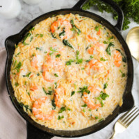 Lemon garlic shrimp with orzo in a large cast iron pan.