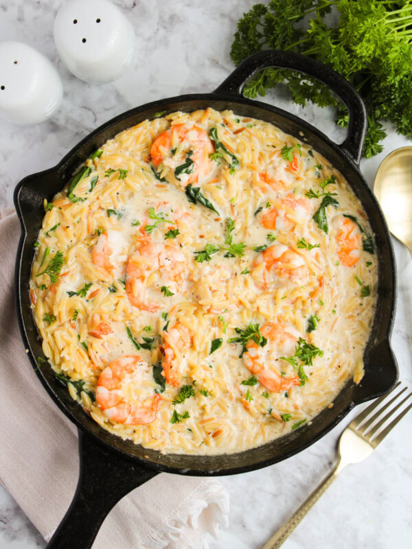 Lemon garlic shrimp with orzo in a large cast iron pan.