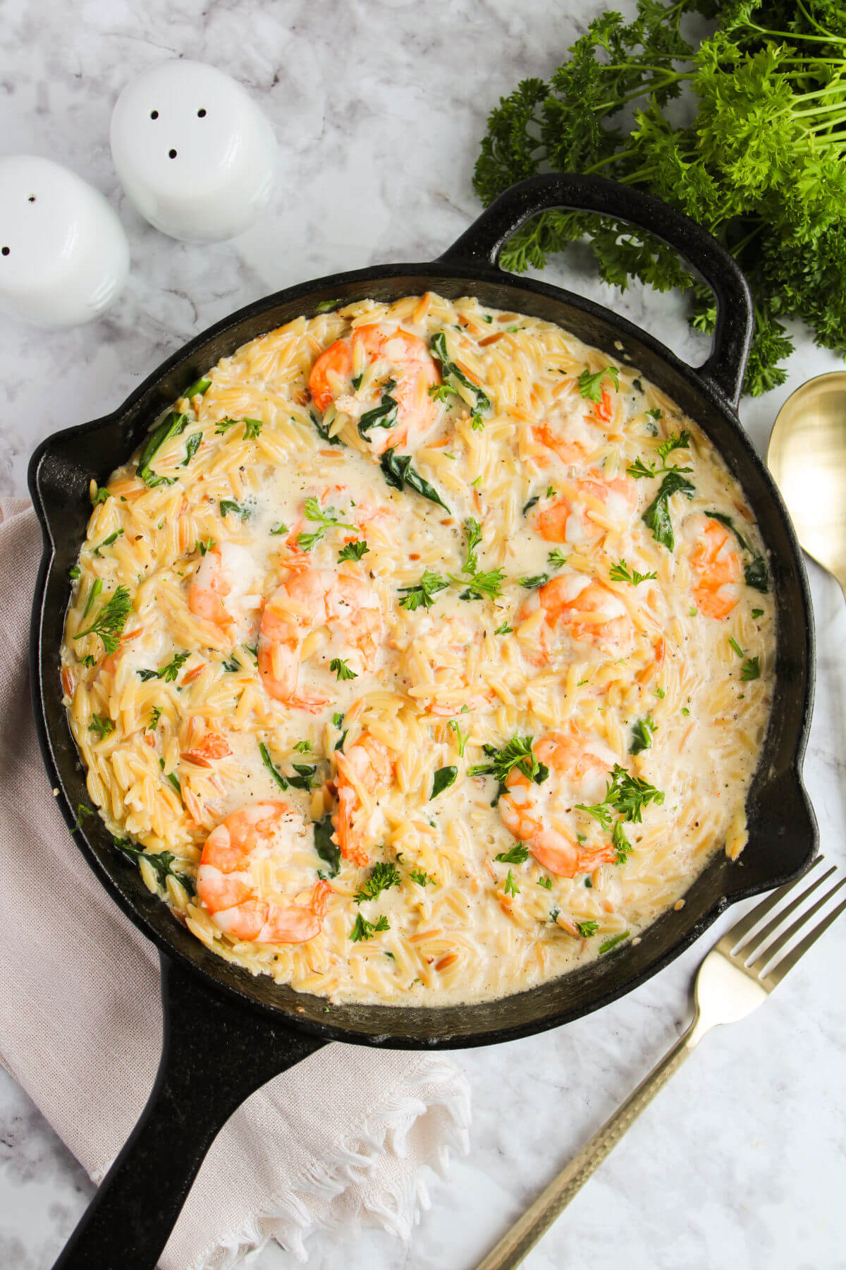 Lemon garlic shrimp with orzo in a large cast iron pan.