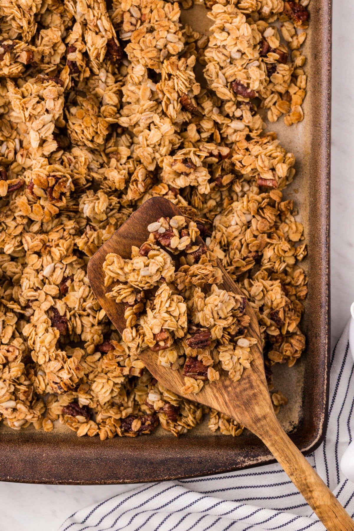 Maple granola recipe on a cookie sheet after baking.