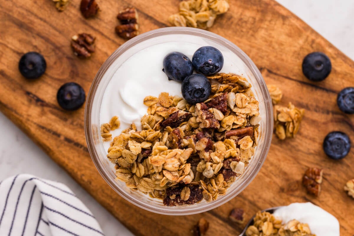 Maple granola recipe served over yogurt.