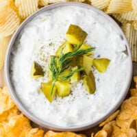 Easy pickle dip recipe in a bowl surrounded by chips.