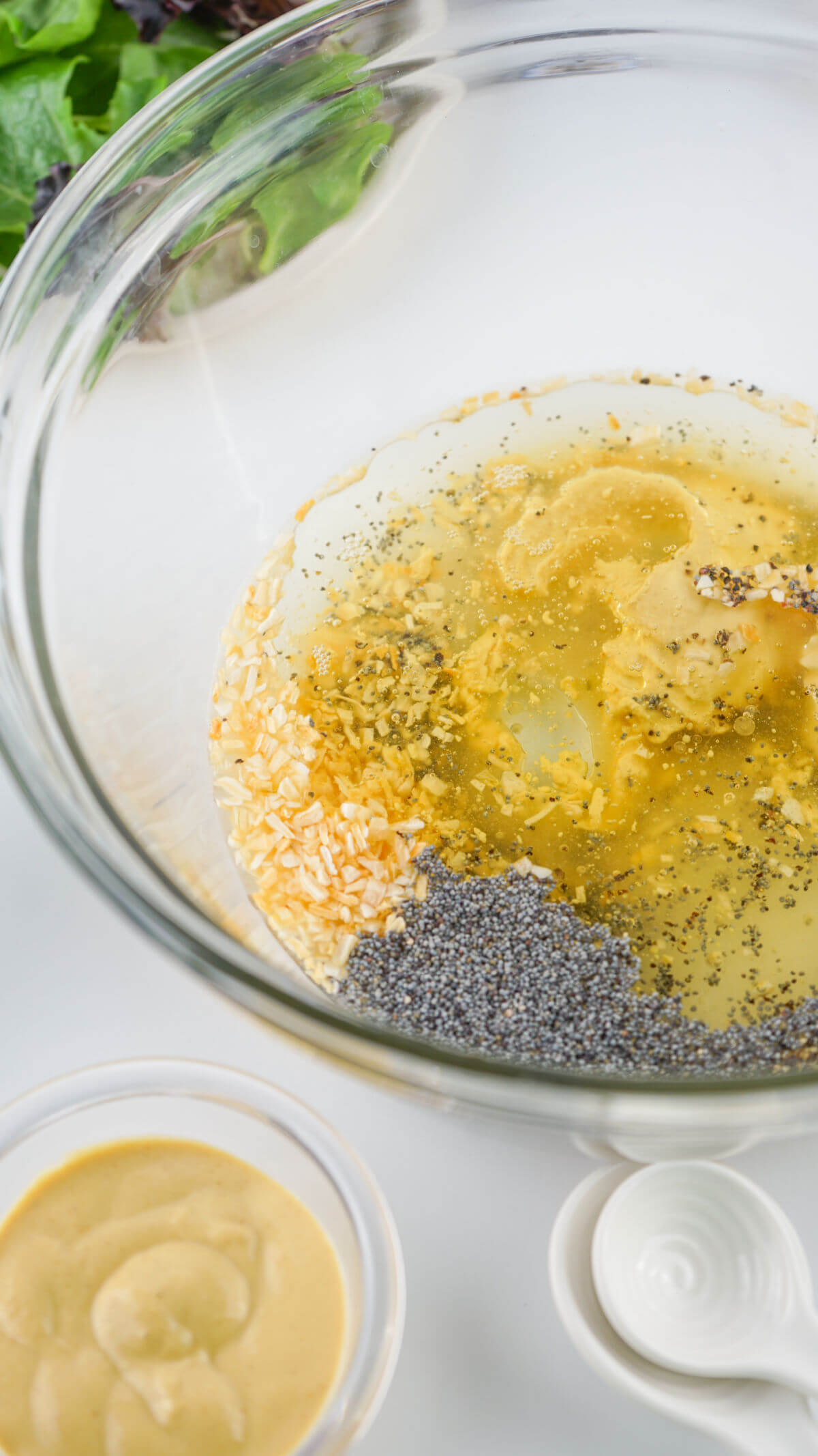 Mixing ingredients for homemade poppy seed dressing in a bowl.