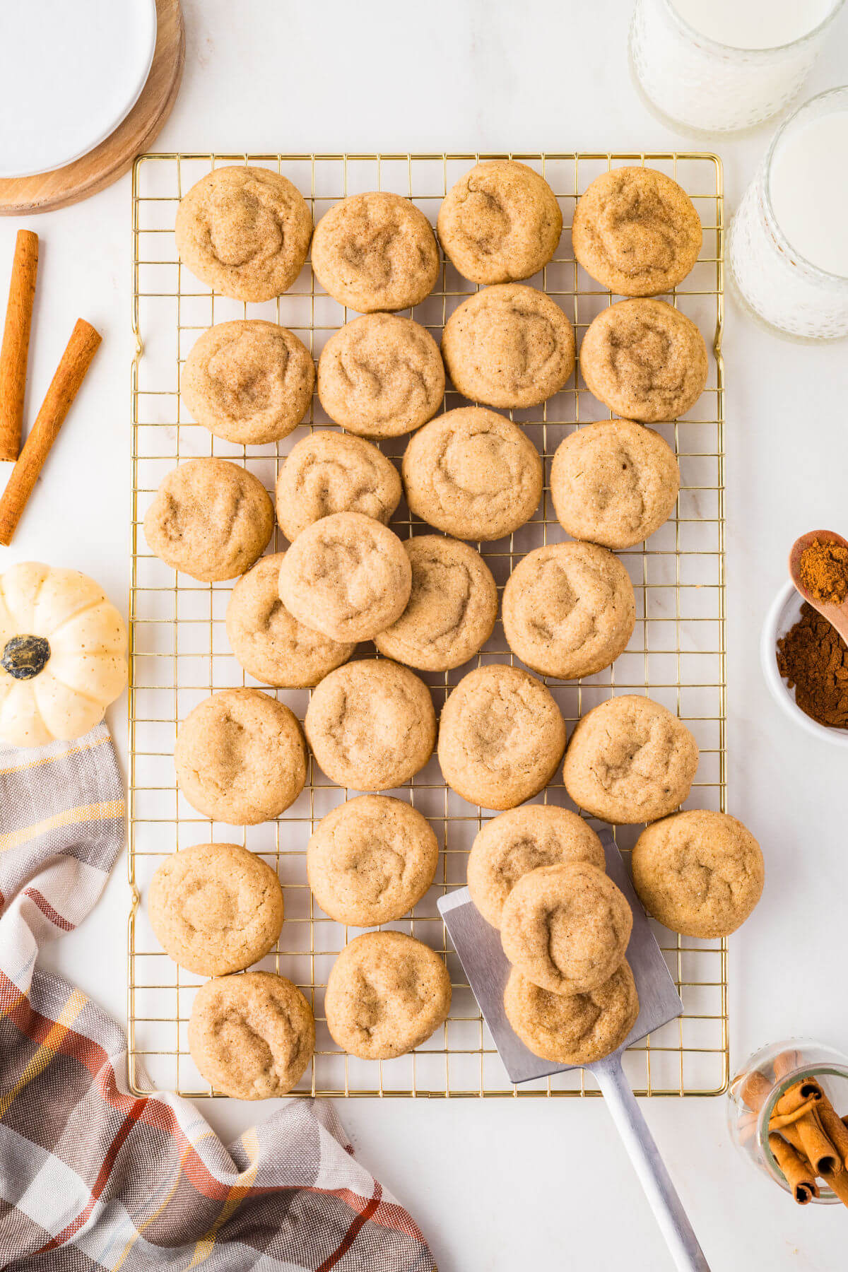 Pumpkin pie spice cookies on a wire cooling rack.