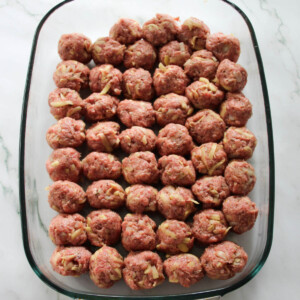 Savory meatballs in a glass baking dish.
