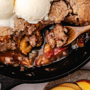 Skillet peach cobbler with ice cream.