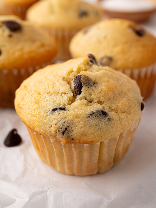 Sourdough chocolate chip muffins on a piece of parchment paper.