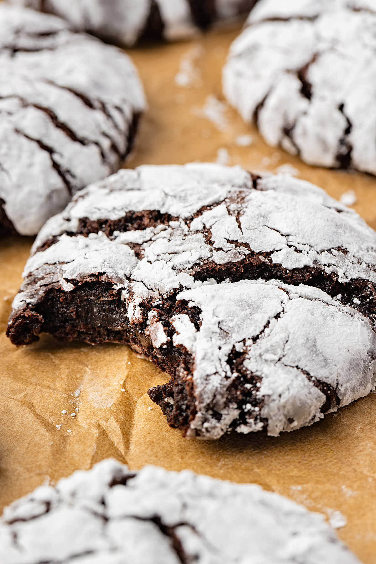 Sourdough chocolate crinkle cookies on parchment paper.