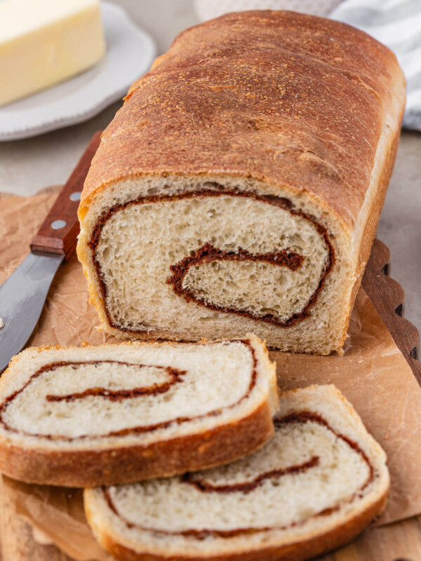 Sourdough cinnamon swirl bread on a wooden cutting board.