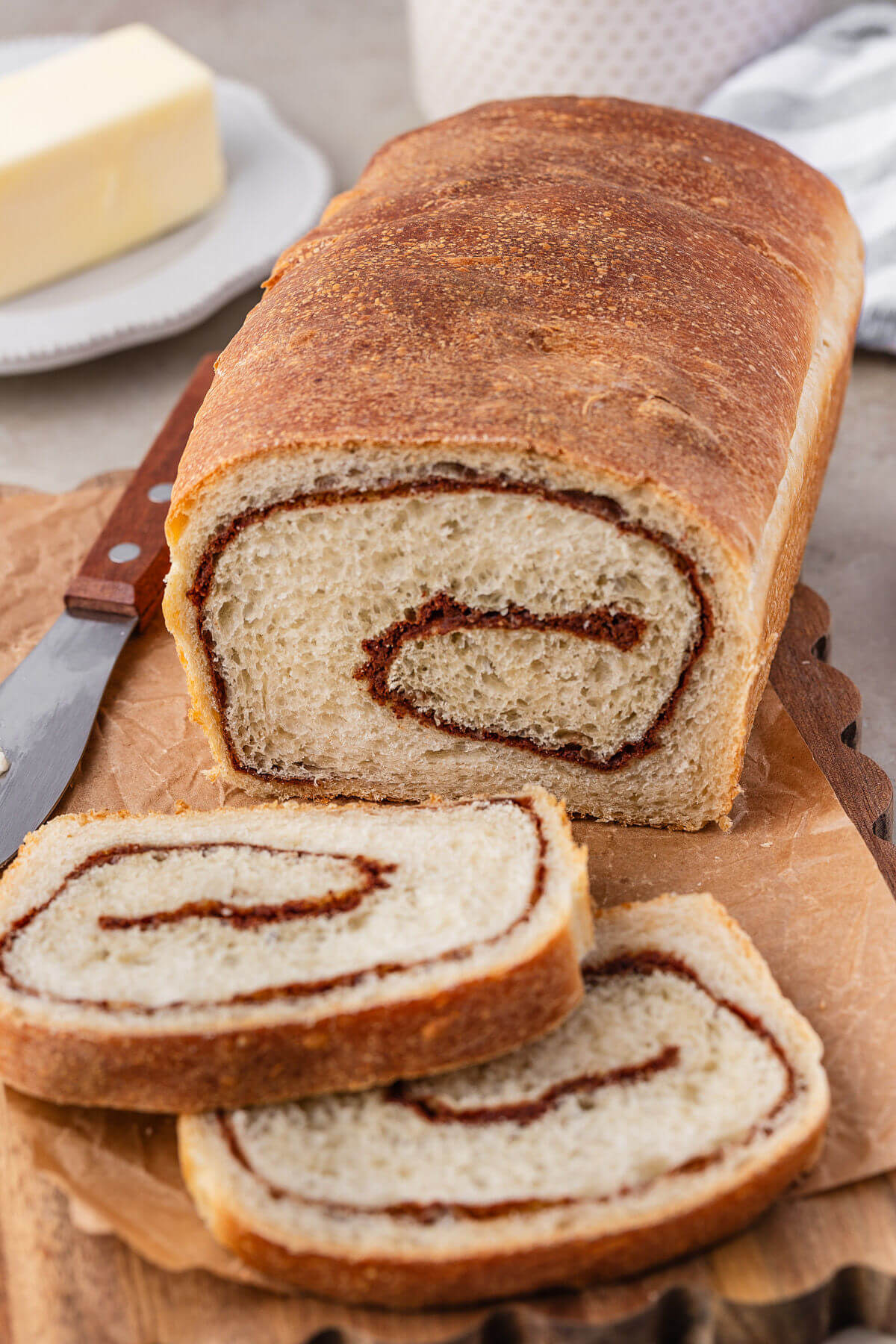 Sourdough cinnamon swirl bread on a wooden cutting board.