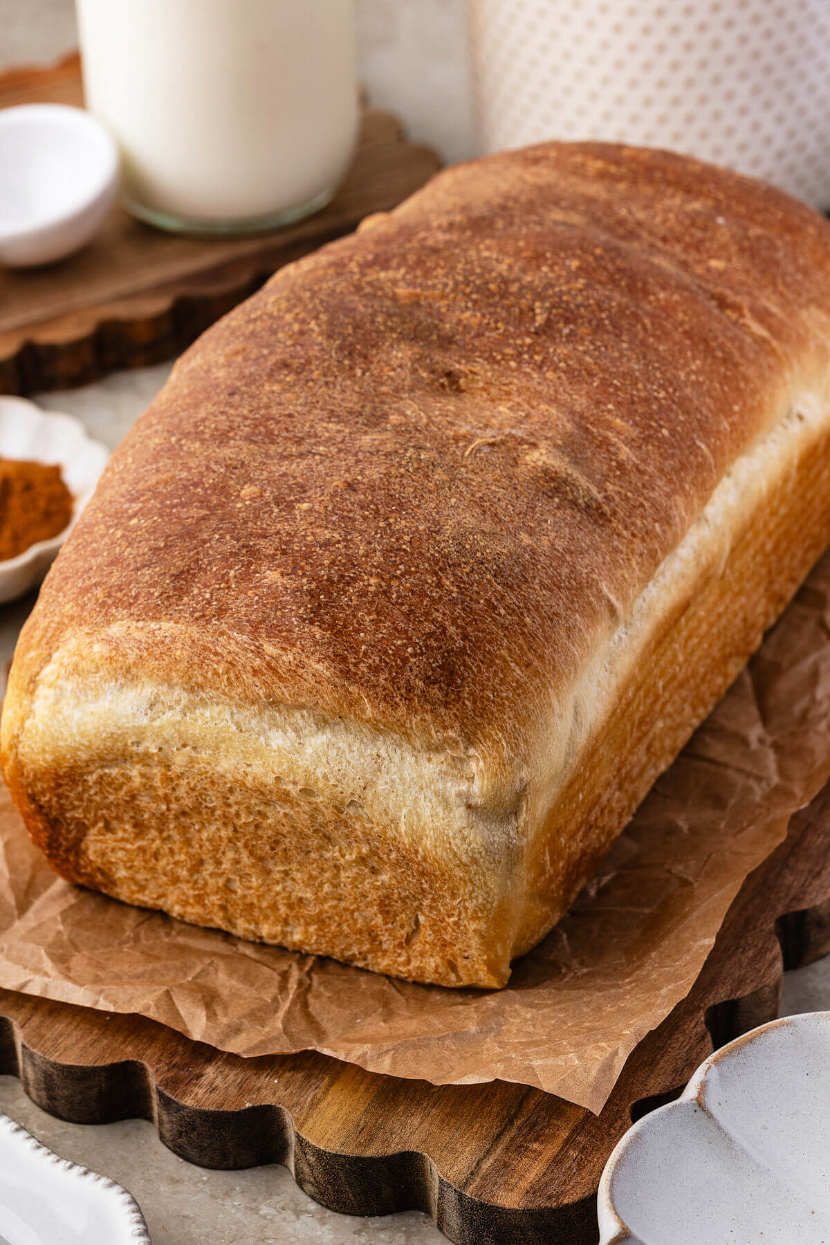 Sourdough cinnamon swirl bread on a cutting board ready to be sliced.
