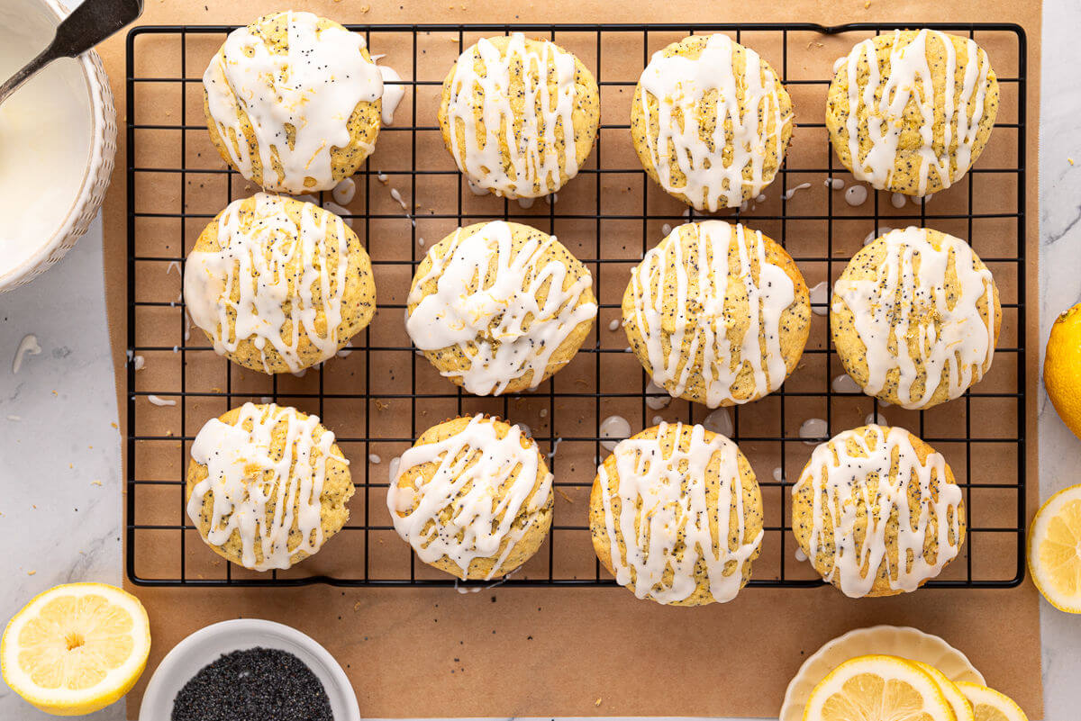 Sourdough lemon poppy seed muffins on a wire rack.