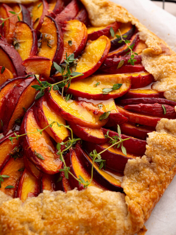Sourdough peach galette on parchment paper.