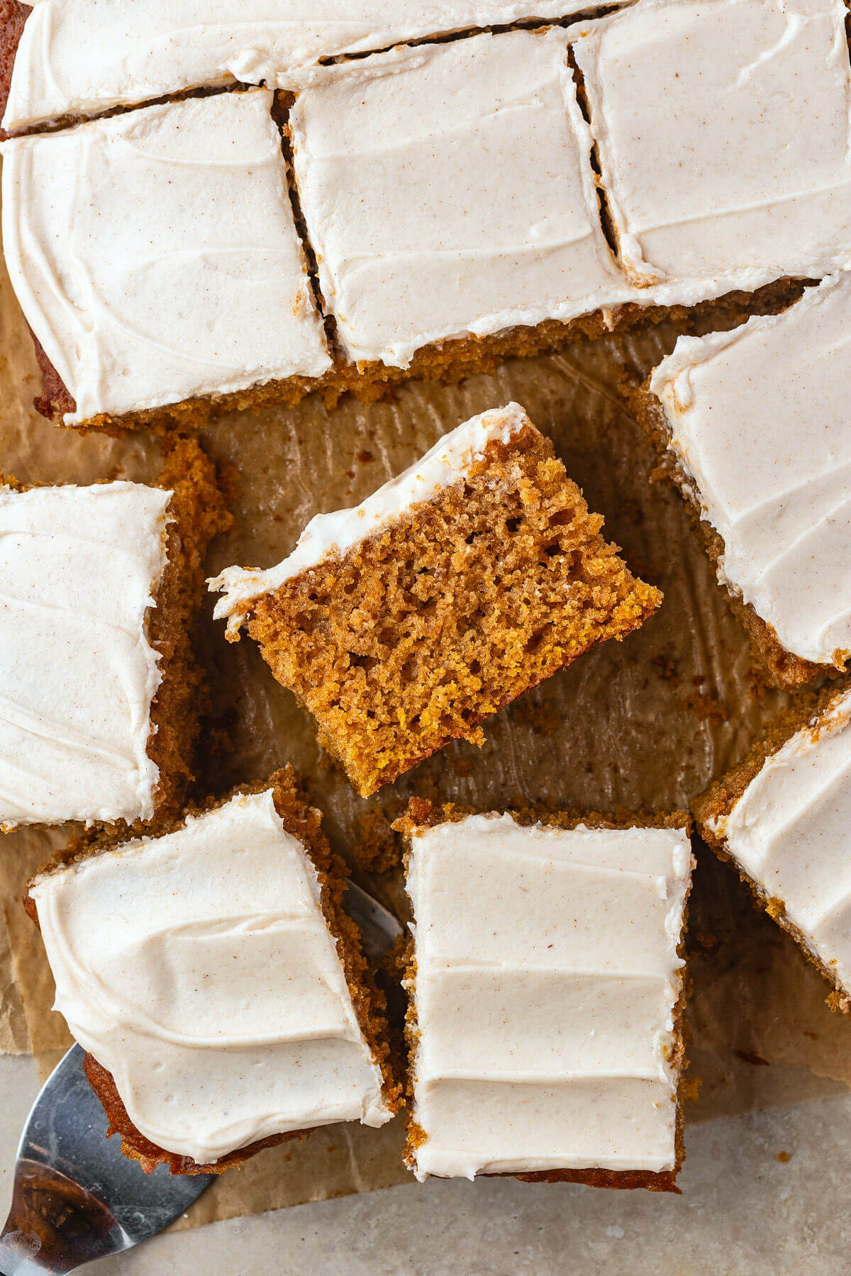 Sourdough pumpkin bars cut into bars and frosted with cream cheese frosting.