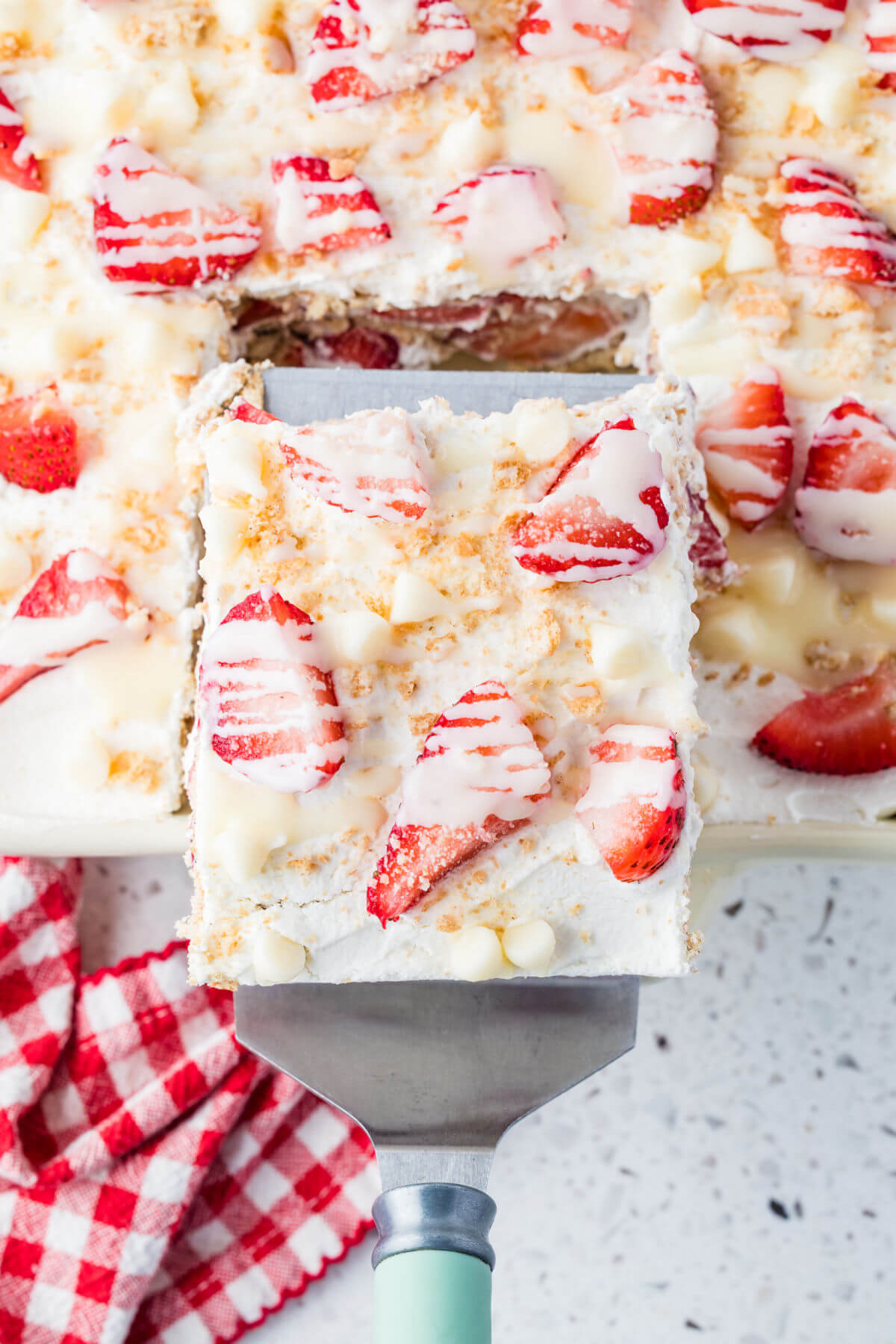 Strawberry icebox cake with a piece cut out for serving.