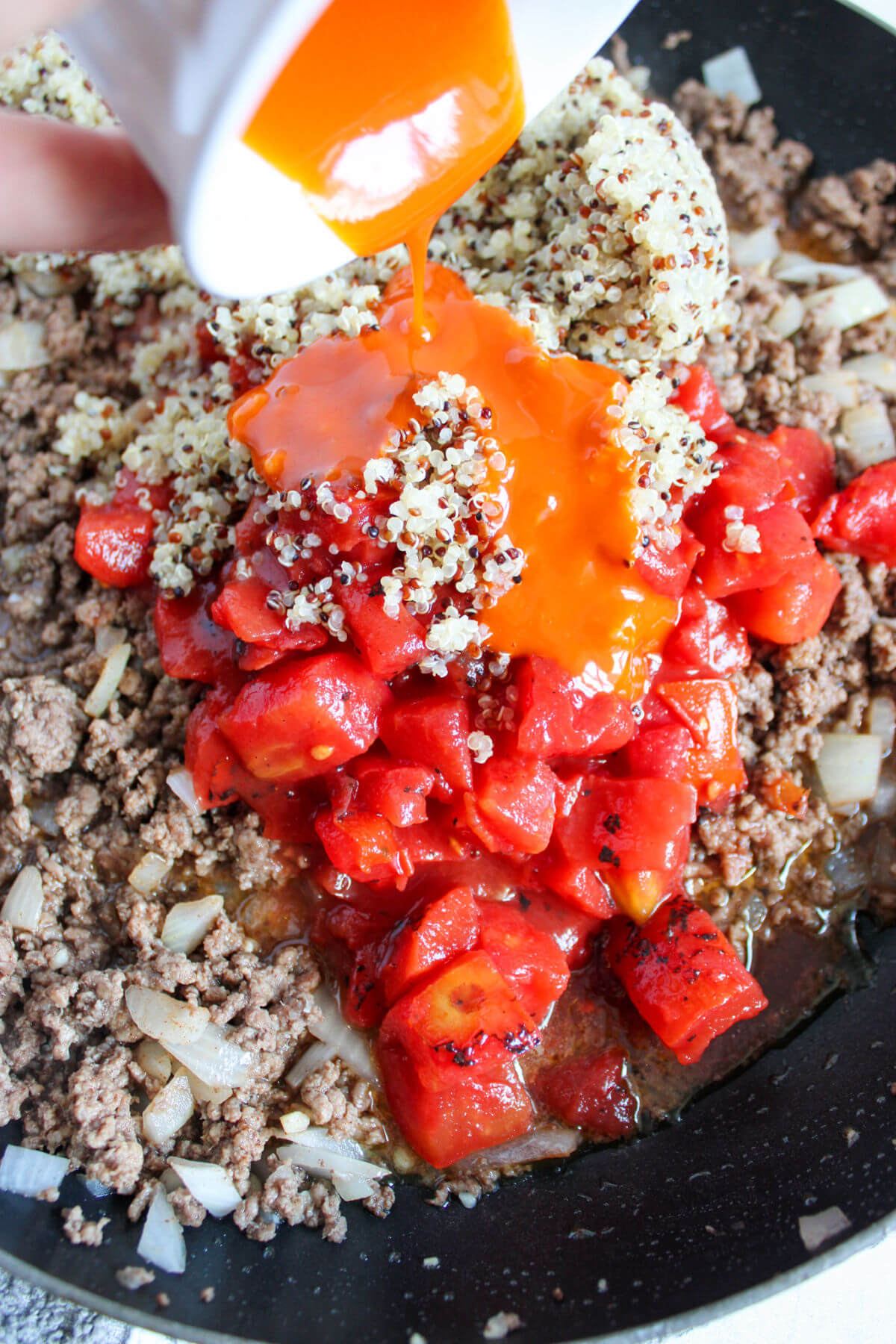 Making quinoa stuffed peppers in a cast iron skillet.