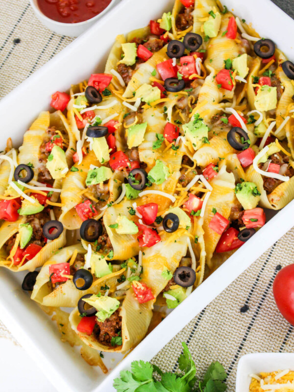 Taco stuffed shells in a baking dish.