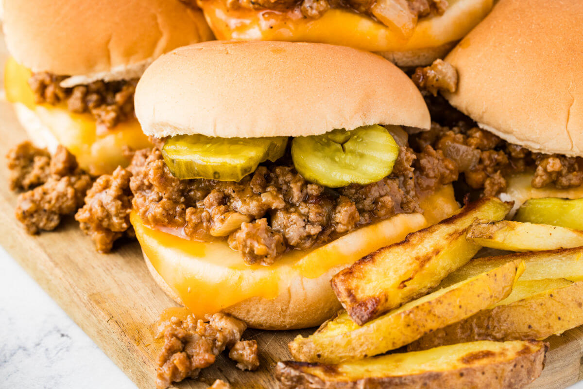 Turkey sloppy joes on a wooden cutting board.
