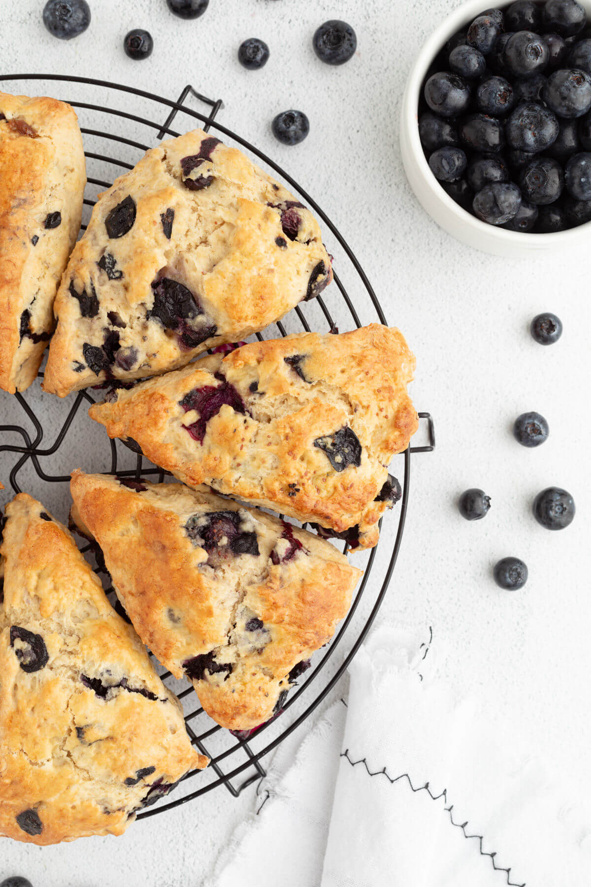 Sourdough blueberry scones slices on a wire cooling rack.