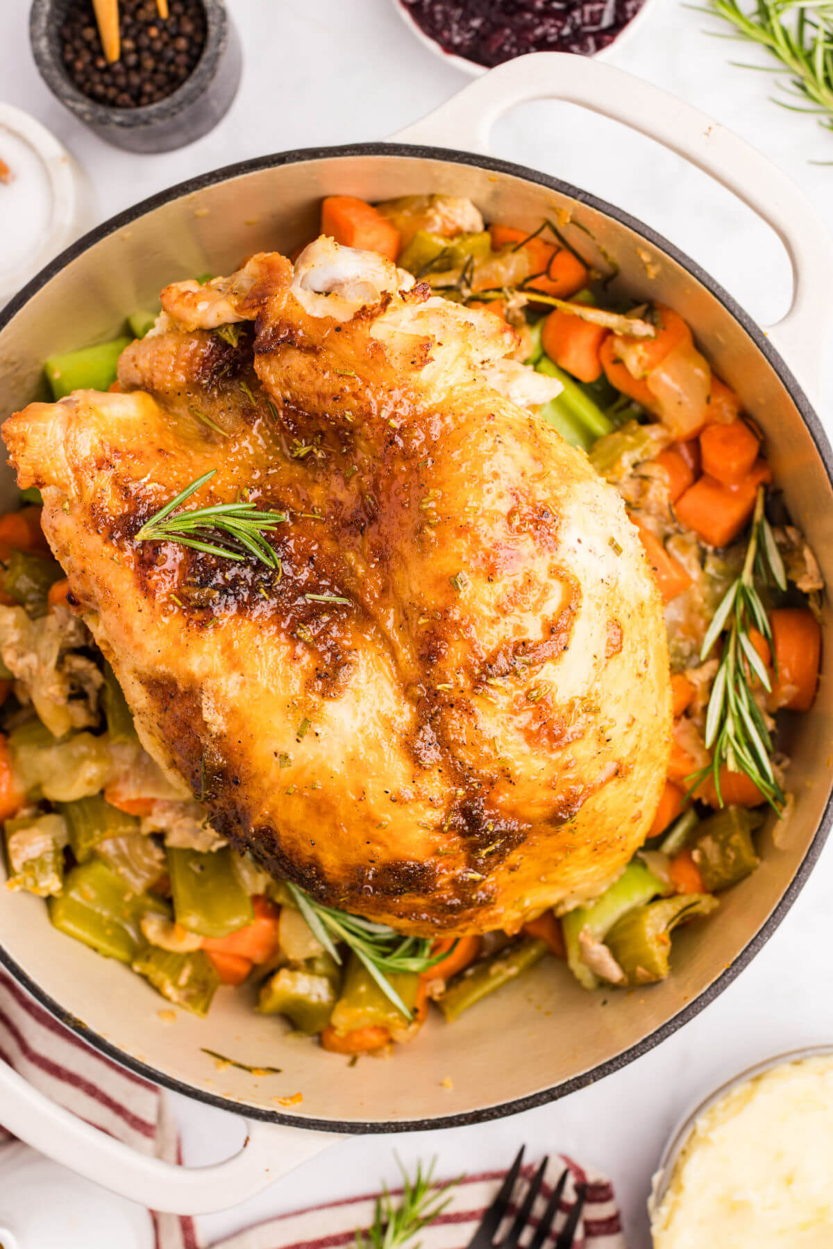 Honey glazed turkey breast with vegetables in a Dutch oven.