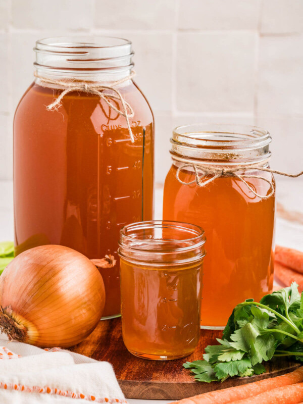 Three glass jars filled with turkey bone broth.