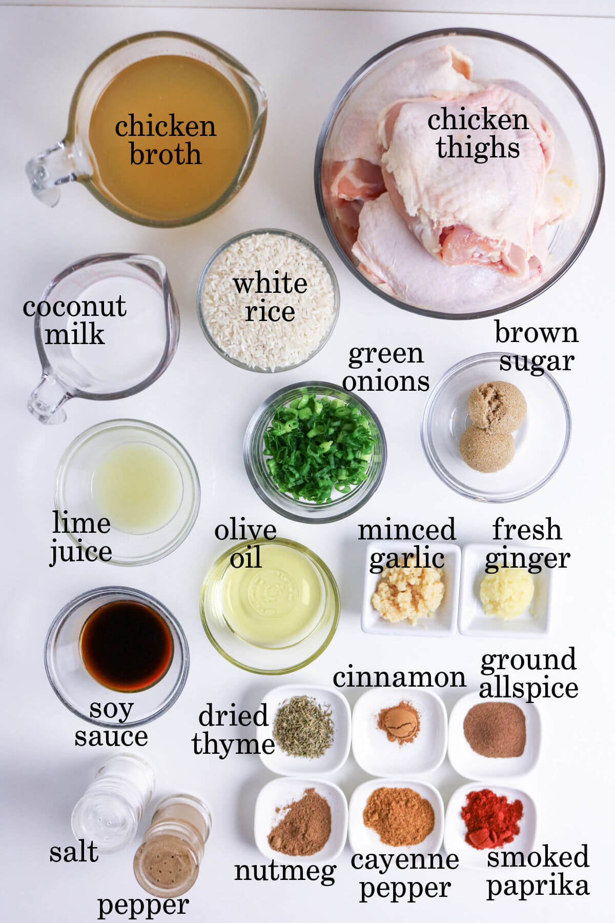 Ingredients for jerk chicken and rice in small bowls.