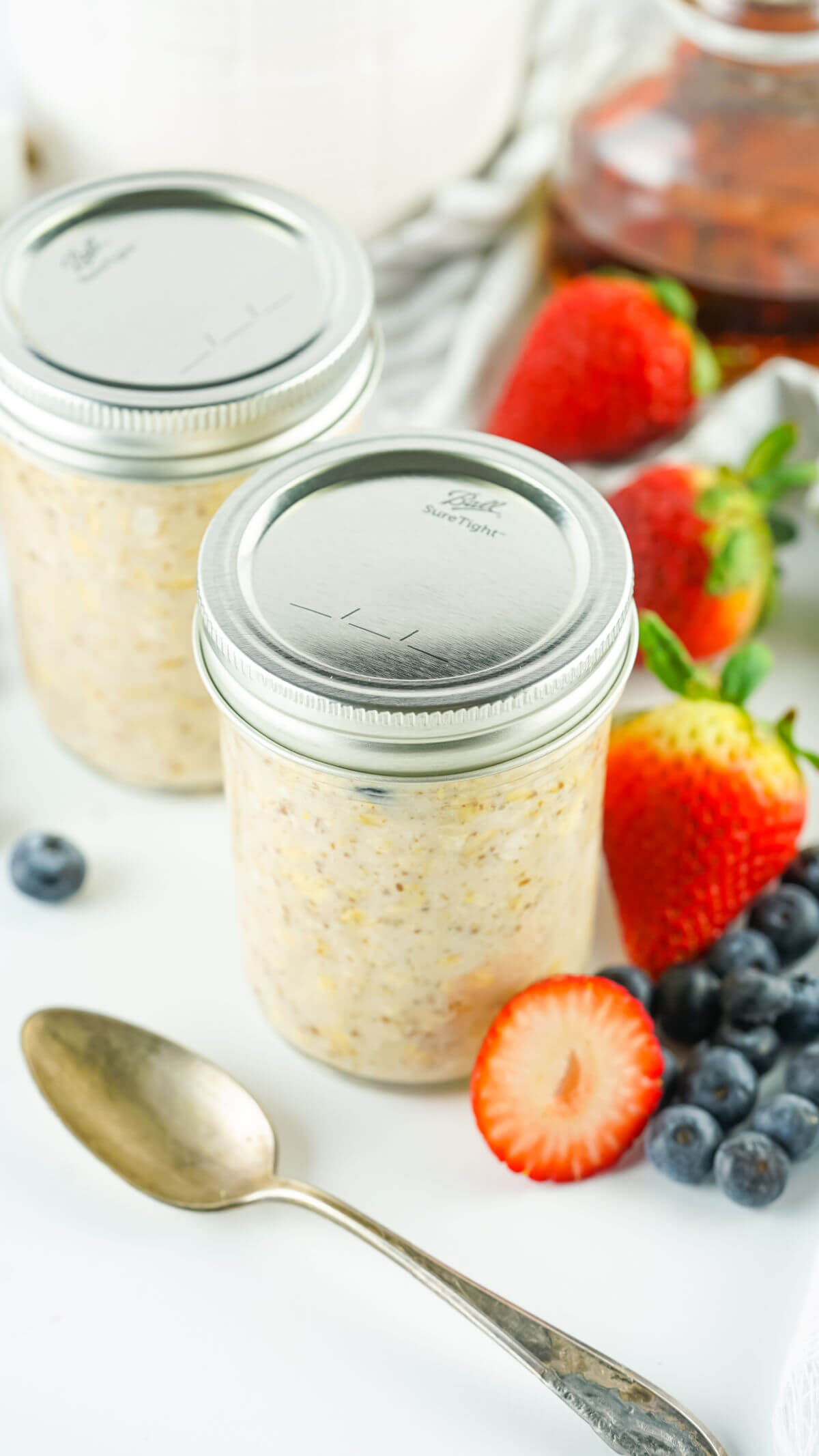 Two jars of lactation overnight oats with lids on.