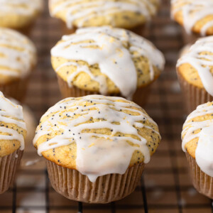 Sourdough lemon poppy seed muffins on a wire rack.