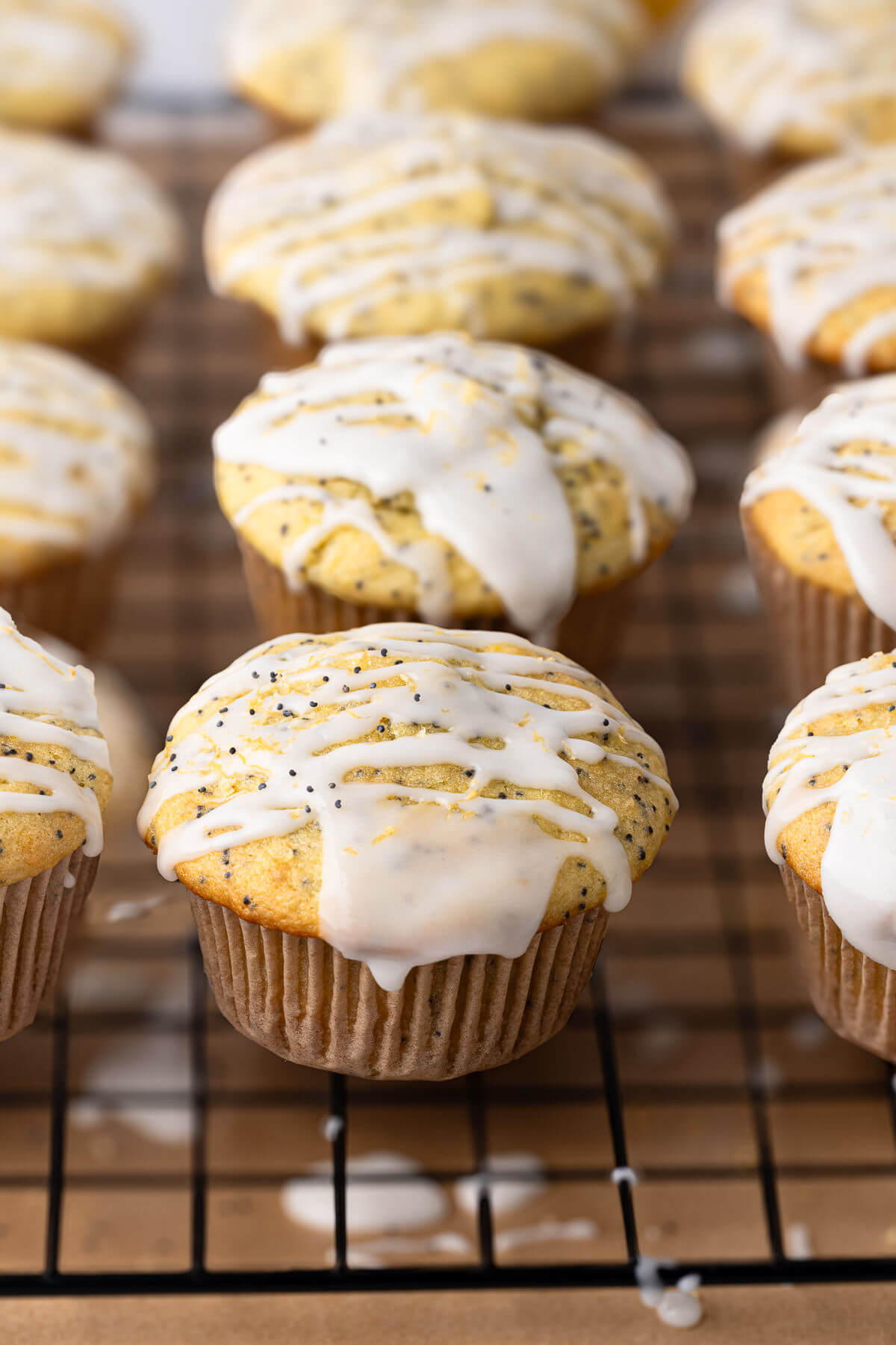 Sourdough lemon poppy seed muffins on a wire rack.