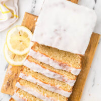 Sliced loaf of sourdough lemon bread on a cutting board.