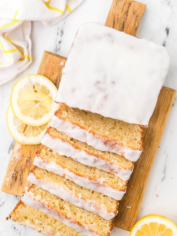 Sliced loaf of sourdough lemon bread on a cutting board.