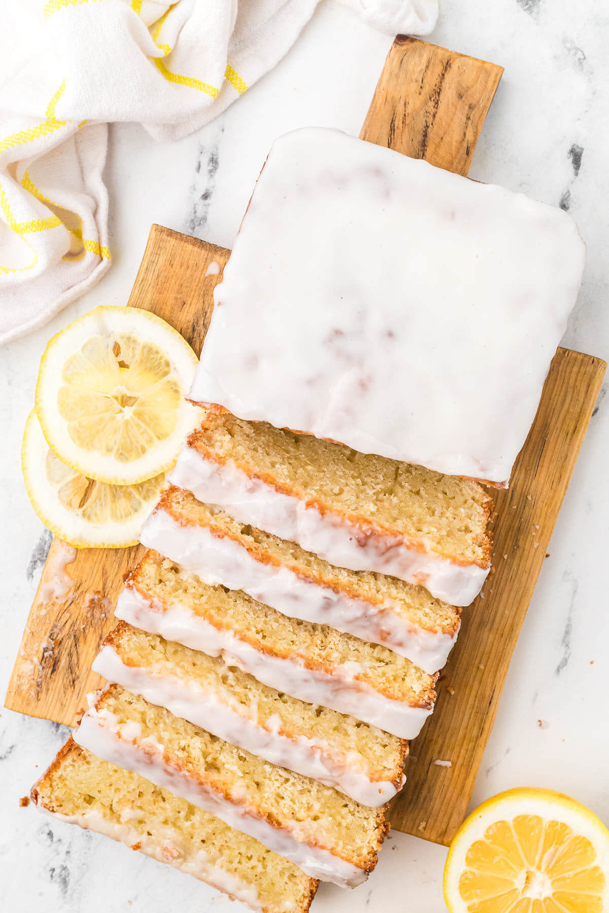 Sliced loaf of sourdough lemon bread on a cutting board.