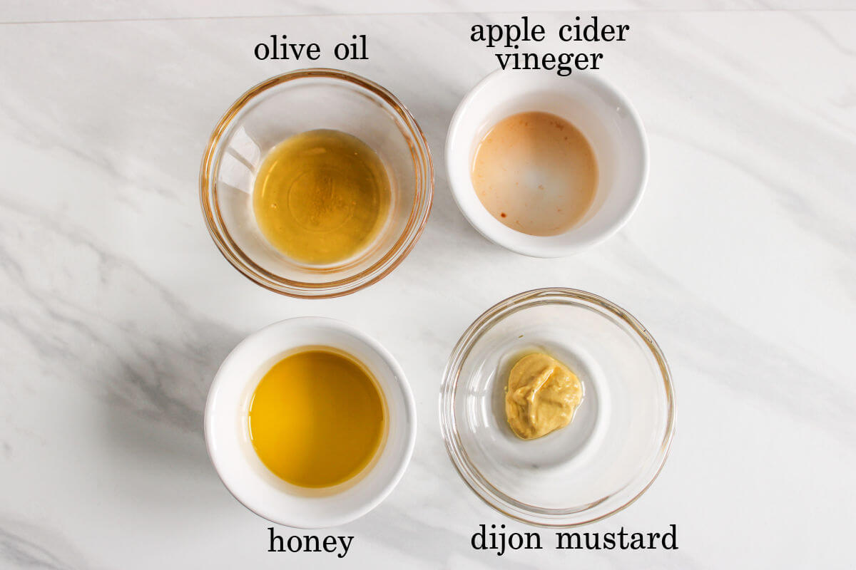 Ingredients used to make a honey mustard vinaigrette dressing.
