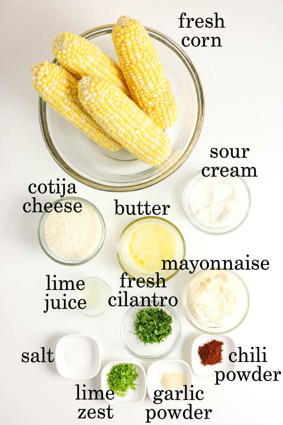 Ingredients for easy Mexican street corn in small bowls.