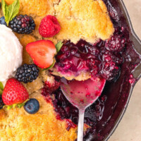 Sourdough mixed berry cobbler in a cast iron skillet.
