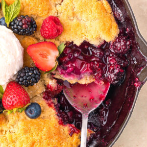 Sourdough mixed berry cobbler in a cast iron skillet.