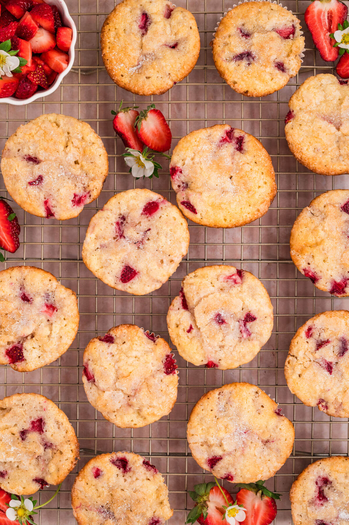 Strawberry muffins cooling on a wire cooling rack.