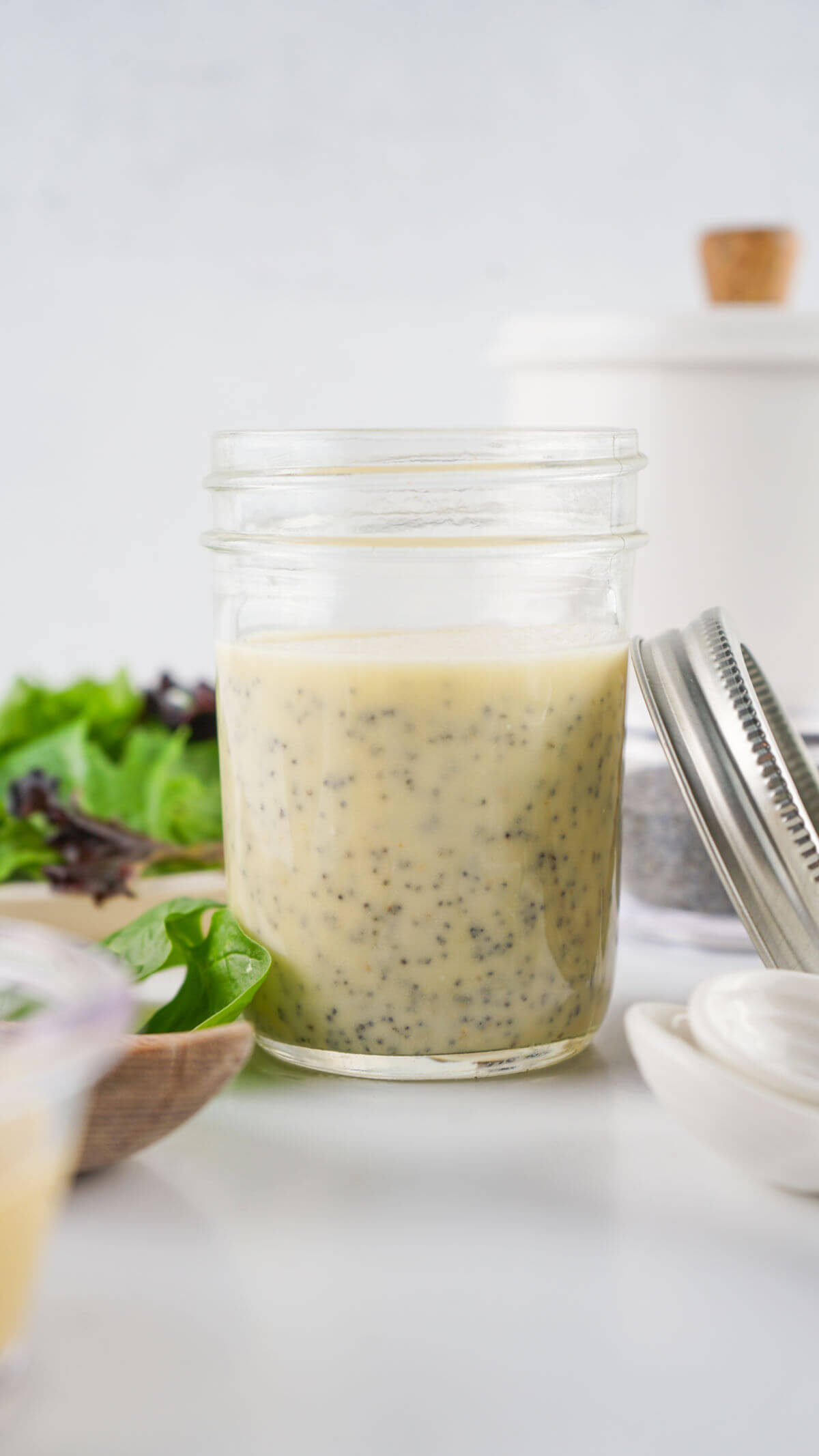 Homemade poppy seed dressing in a glass jar.