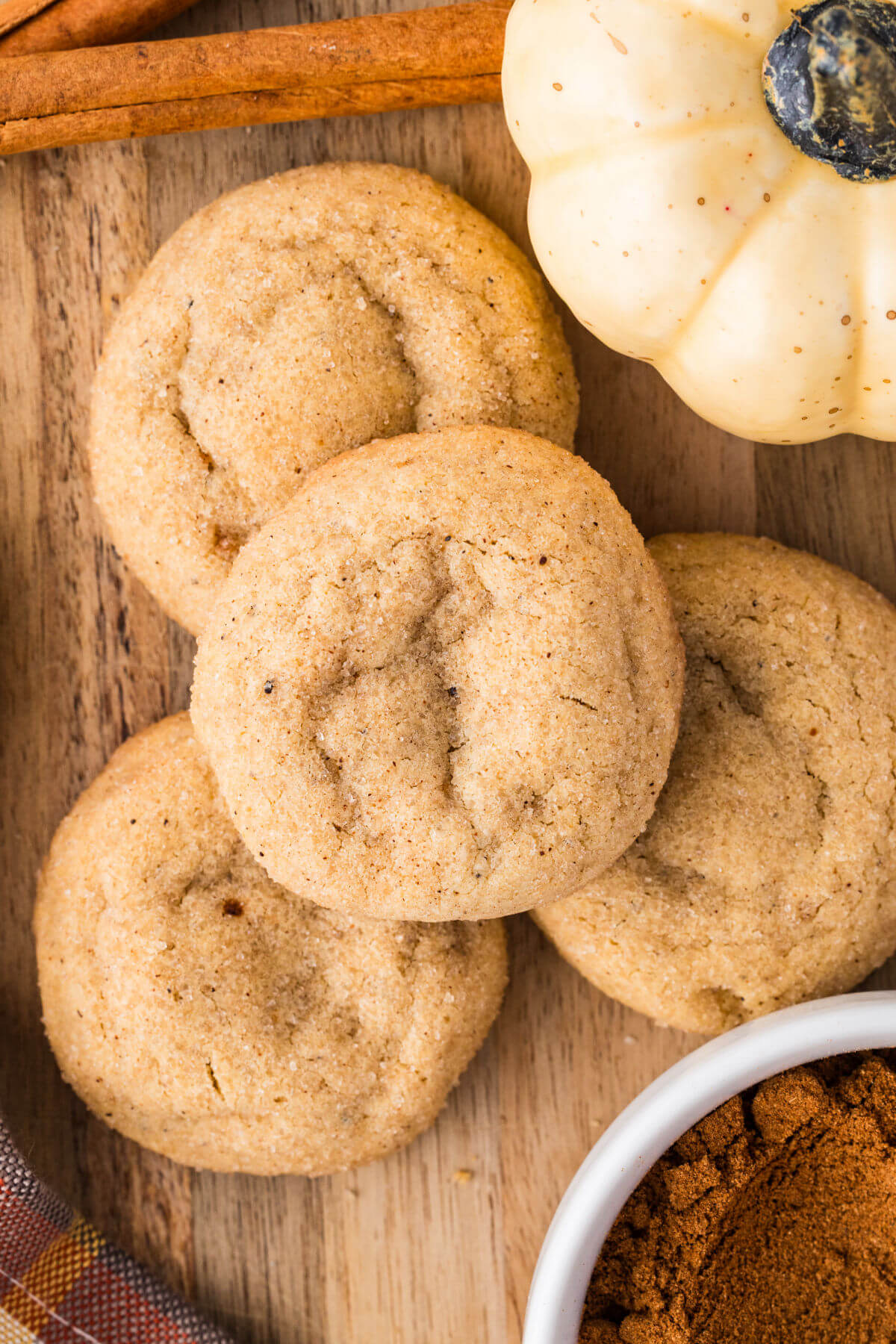 Pumpkin pie spice cookies on a wooden board.
